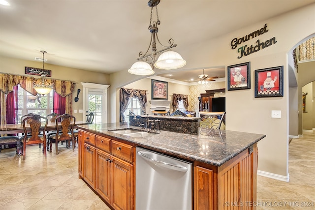 kitchen featuring sink, dishwasher, ceiling fan, pendant lighting, and a center island with sink