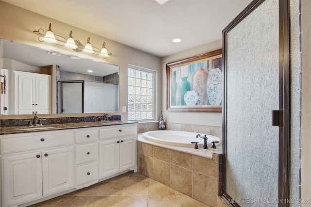 bathroom featuring vanity, plus walk in shower, and tile patterned flooring