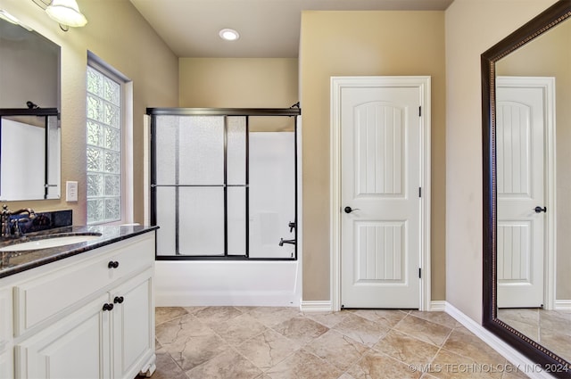 bathroom featuring vanity and combined bath / shower with glass door