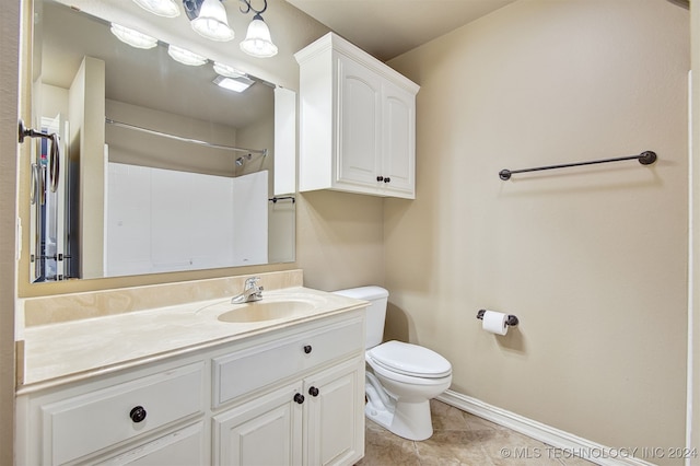 bathroom with vanity, toilet, tile patterned floors, and a shower