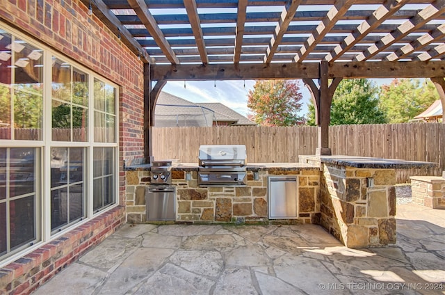 view of patio featuring an outdoor kitchen, grilling area, and a pergola