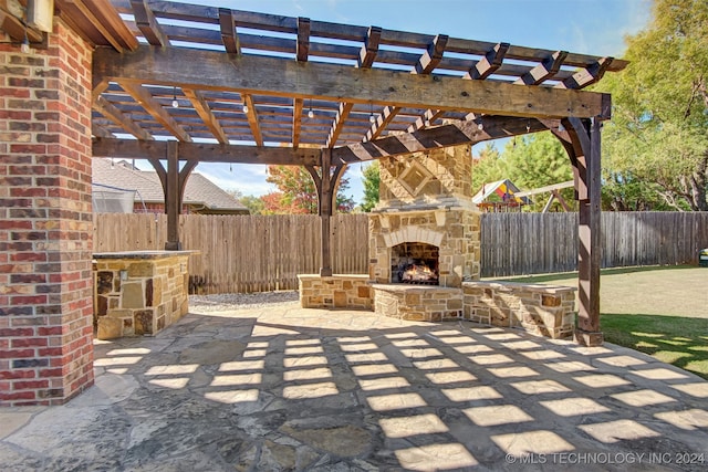 view of patio with a pergola and an outdoor stone fireplace