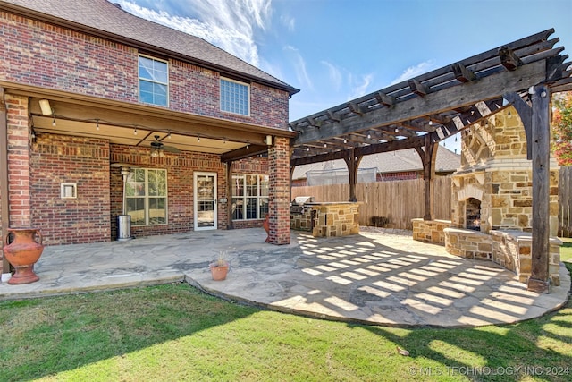 back of property with a yard, a pergola, a patio area, and an outdoor stone fireplace