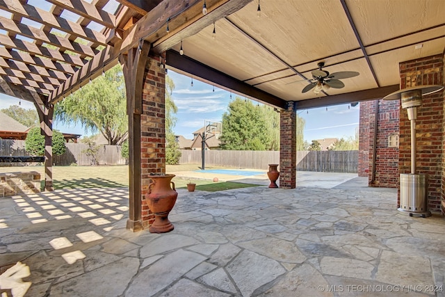 view of patio / terrace with a pergola, ceiling fan, and a swimming pool