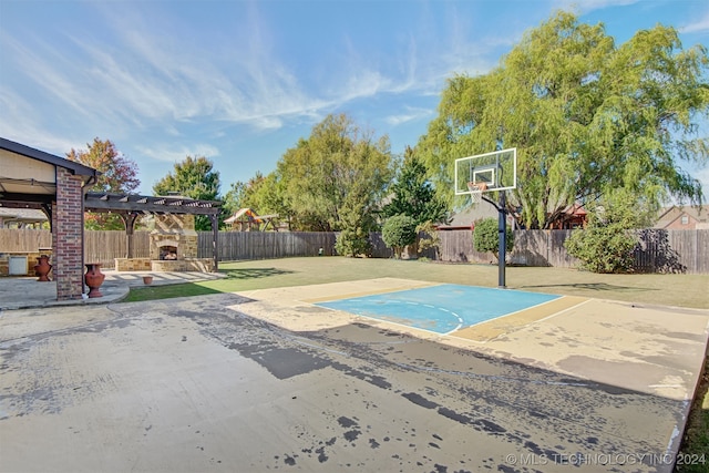 view of basketball court with a lawn