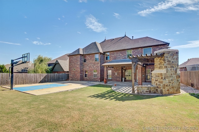 rear view of property featuring a patio, basketball court, a lawn, and a pergola