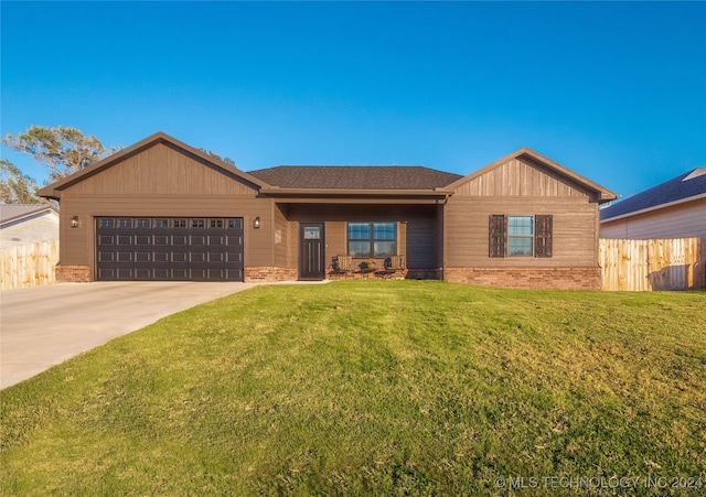 single story home featuring a front yard and a garage