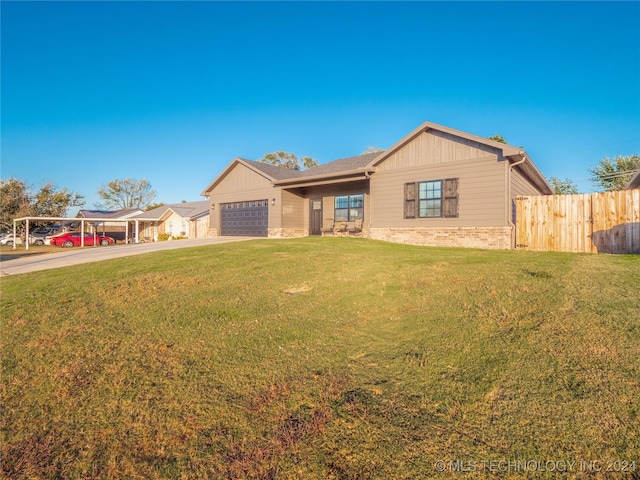 ranch-style house featuring a garage and a front lawn