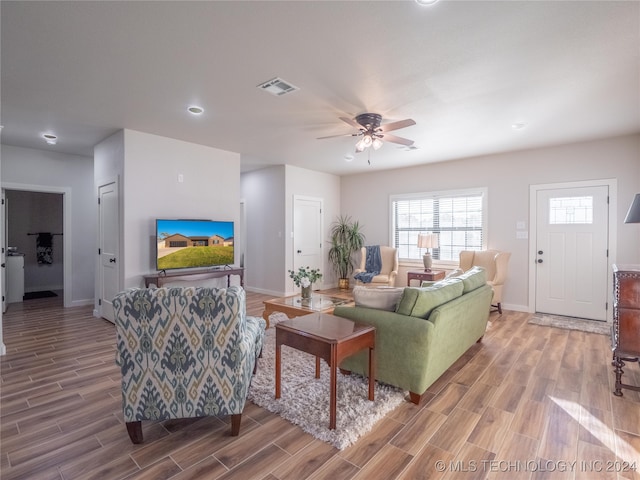 living room with ceiling fan and hardwood / wood-style floors