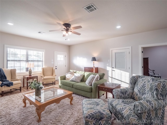 living room with wood-type flooring and ceiling fan