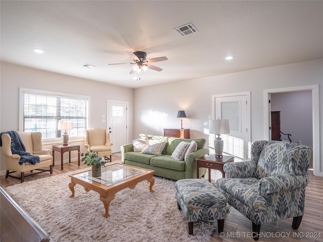 living room featuring hardwood / wood-style floors and ceiling fan