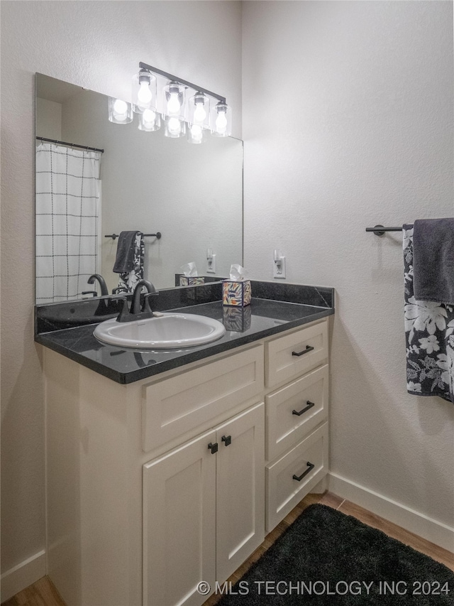 bathroom with vanity and hardwood / wood-style floors