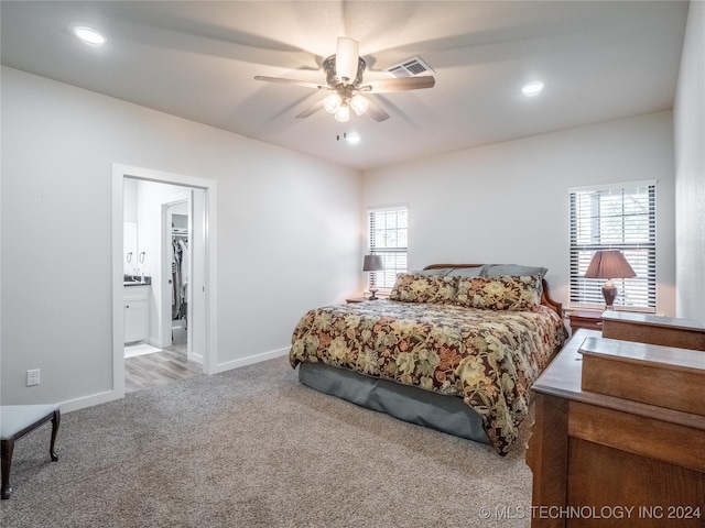 carpeted bedroom with connected bathroom and ceiling fan