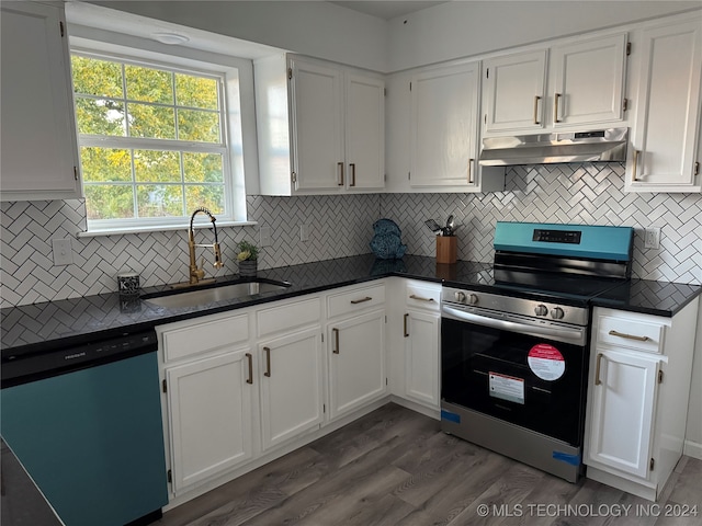 kitchen with appliances with stainless steel finishes, white cabinets, sink, and dark wood-type flooring