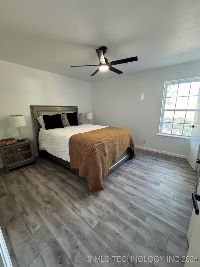 bedroom with hardwood / wood-style floors and ceiling fan