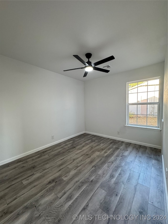 spare room featuring dark hardwood / wood-style floors and ceiling fan