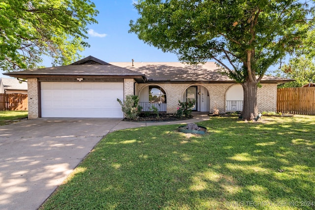 single story home with a front yard and a garage