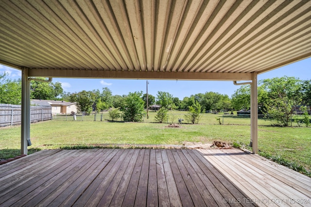 wooden deck featuring a yard