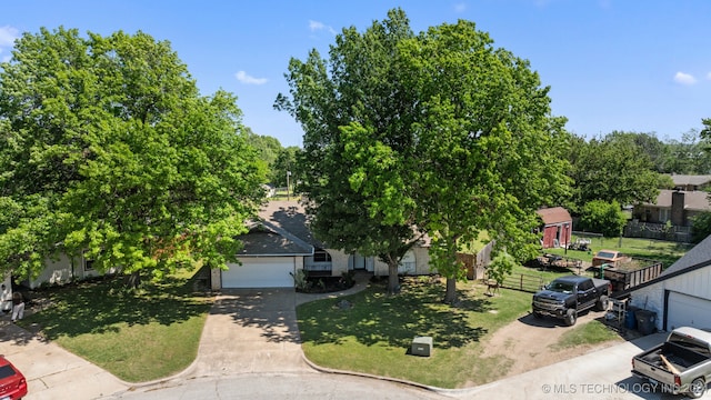 obstructed view of property featuring a front yard and a garage