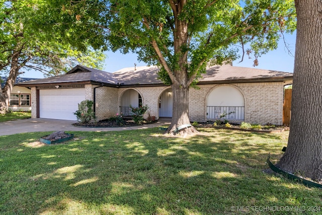 ranch-style home with a front lawn and a garage