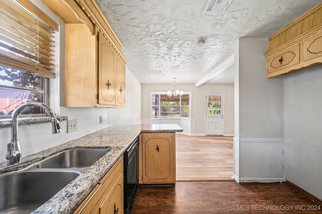 kitchen featuring black dishwasher, a textured ceiling, dark hardwood / wood-style floors, a notable chandelier, and sink