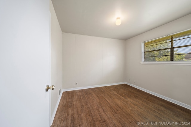 unfurnished room featuring dark hardwood / wood-style floors