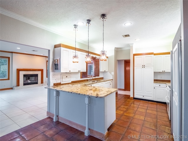 kitchen with kitchen peninsula, white cabinets, decorative light fixtures, and a breakfast bar