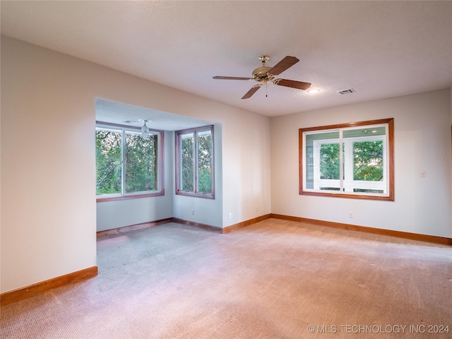 carpeted empty room with ceiling fan