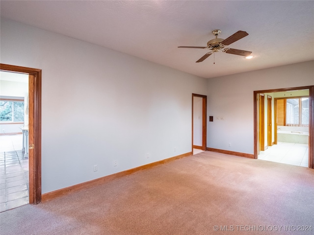 carpeted empty room with ceiling fan