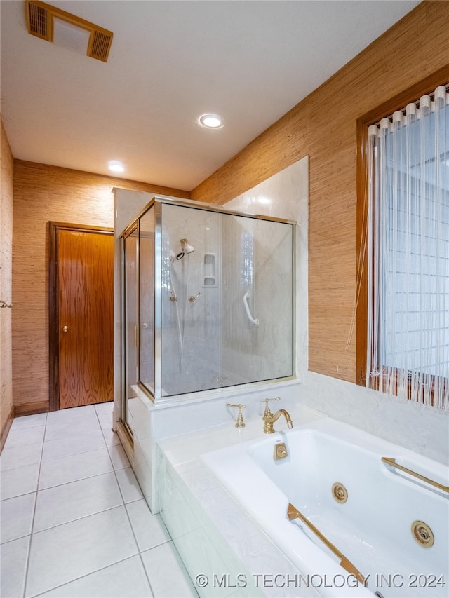 bathroom with separate shower and tub and tile patterned flooring