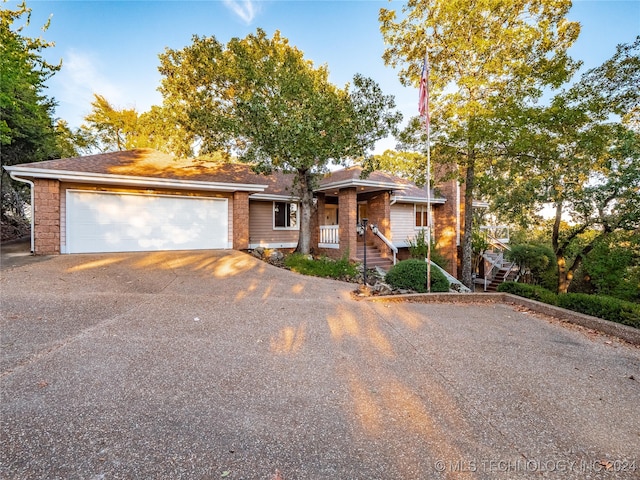 view of front facade featuring covered porch and a garage