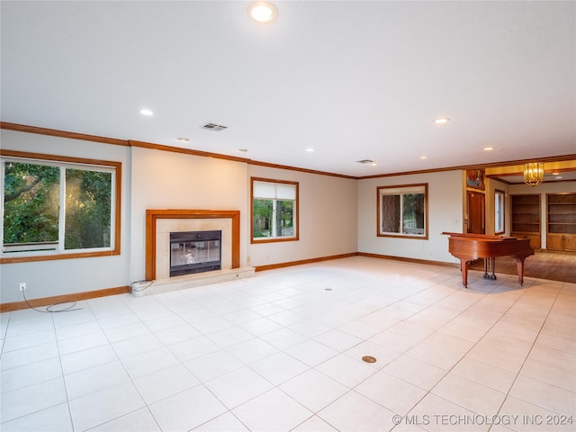 unfurnished living room featuring a notable chandelier, ornamental molding, and light tile patterned floors