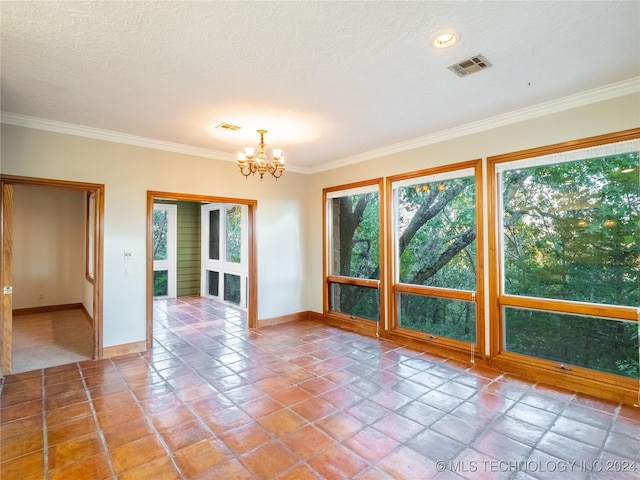 tiled empty room featuring crown molding, a textured ceiling, and a chandelier