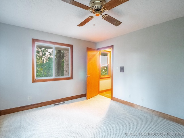 empty room with light carpet and ceiling fan