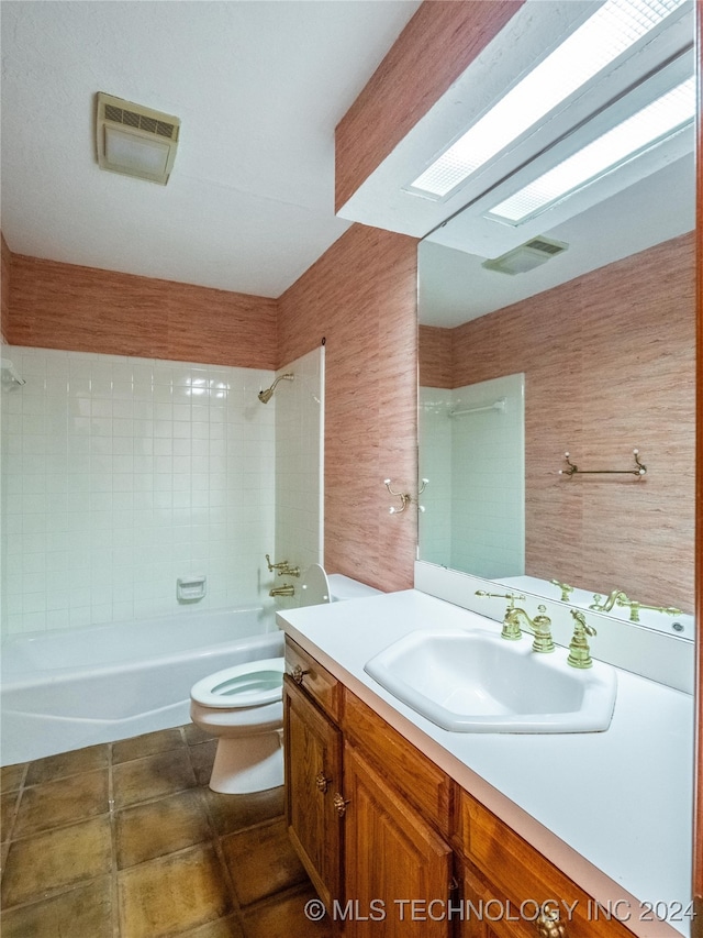 full bathroom with vanity, toilet, and tiled shower / bath combo