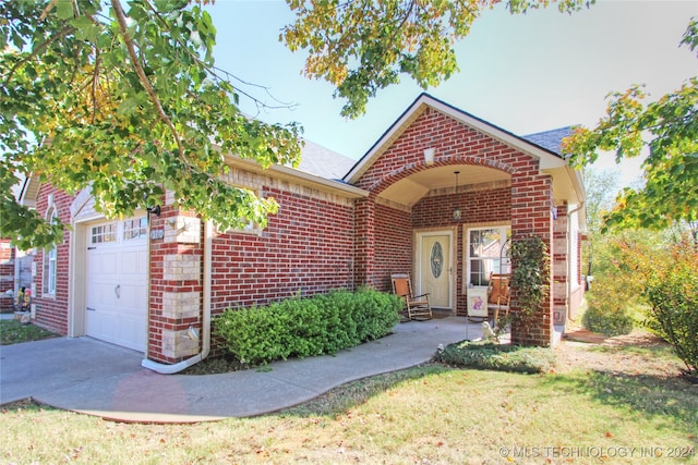 view of front of property featuring a front yard and a garage