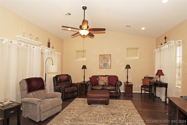 living room featuring dark hardwood / wood-style floors, ceiling fan, and vaulted ceiling