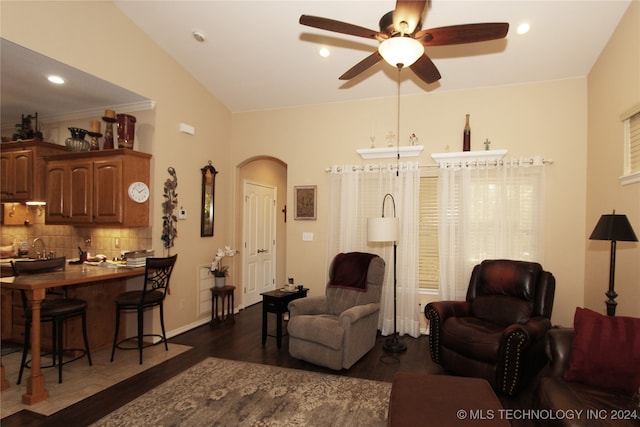 living room with lofted ceiling, dark hardwood / wood-style floors, and ceiling fan