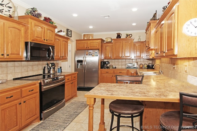 kitchen with crown molding, sink, light tile patterned flooring, and stainless steel appliances