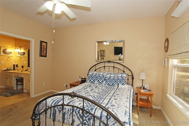 carpeted bedroom with ceiling fan and ensuite bathroom