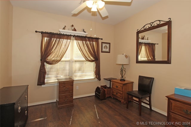 living area featuring ceiling fan and dark hardwood / wood-style floors