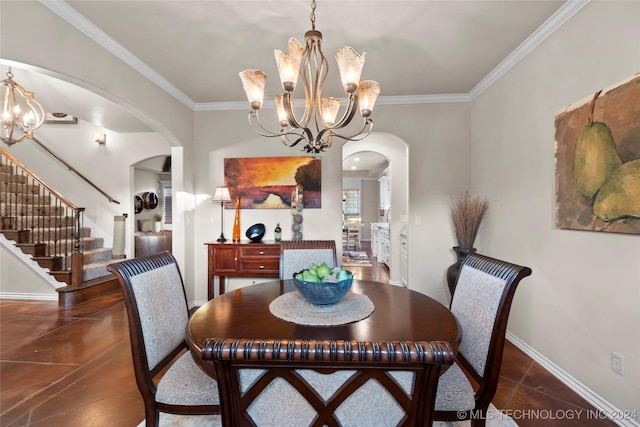 dining space featuring dark tile patterned floors, ornamental molding, and a chandelier