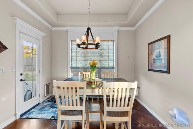 dining room with crown molding, a chandelier, and a tray ceiling