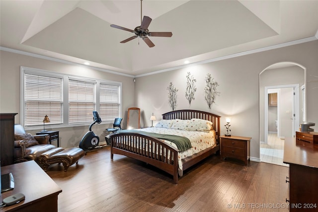 bedroom featuring ceiling fan, crown molding, a raised ceiling, and dark hardwood / wood-style floors