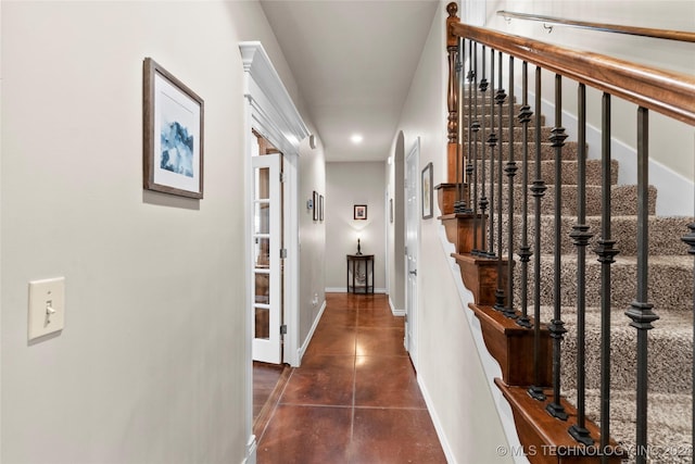 hall with dark tile patterned flooring