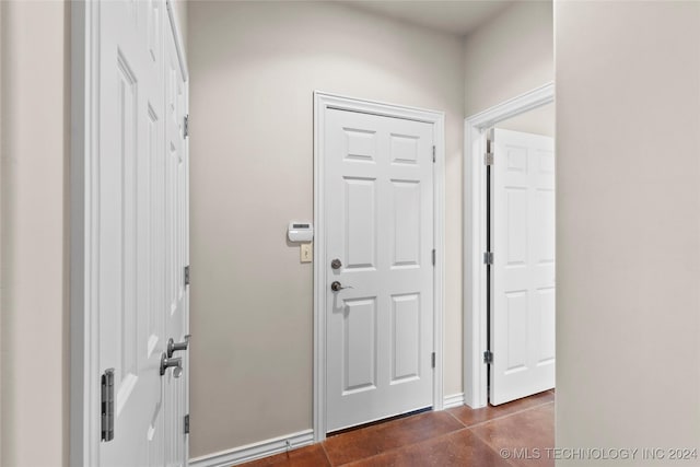 foyer entrance with dark tile patterned flooring