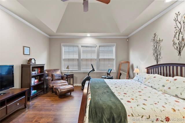 bedroom featuring dark wood-type flooring, a raised ceiling, crown molding, and ceiling fan