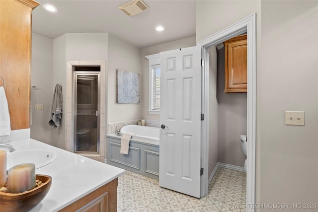 full bathroom featuring vanity, independent shower and bath, and toilet