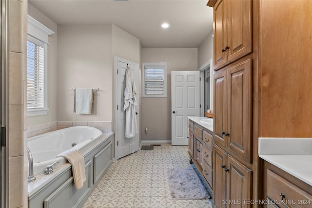 bathroom with vanity and a washtub