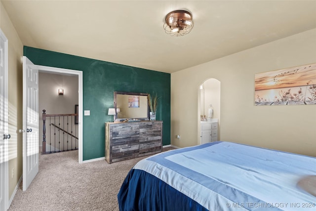 bedroom featuring connected bathroom and carpet